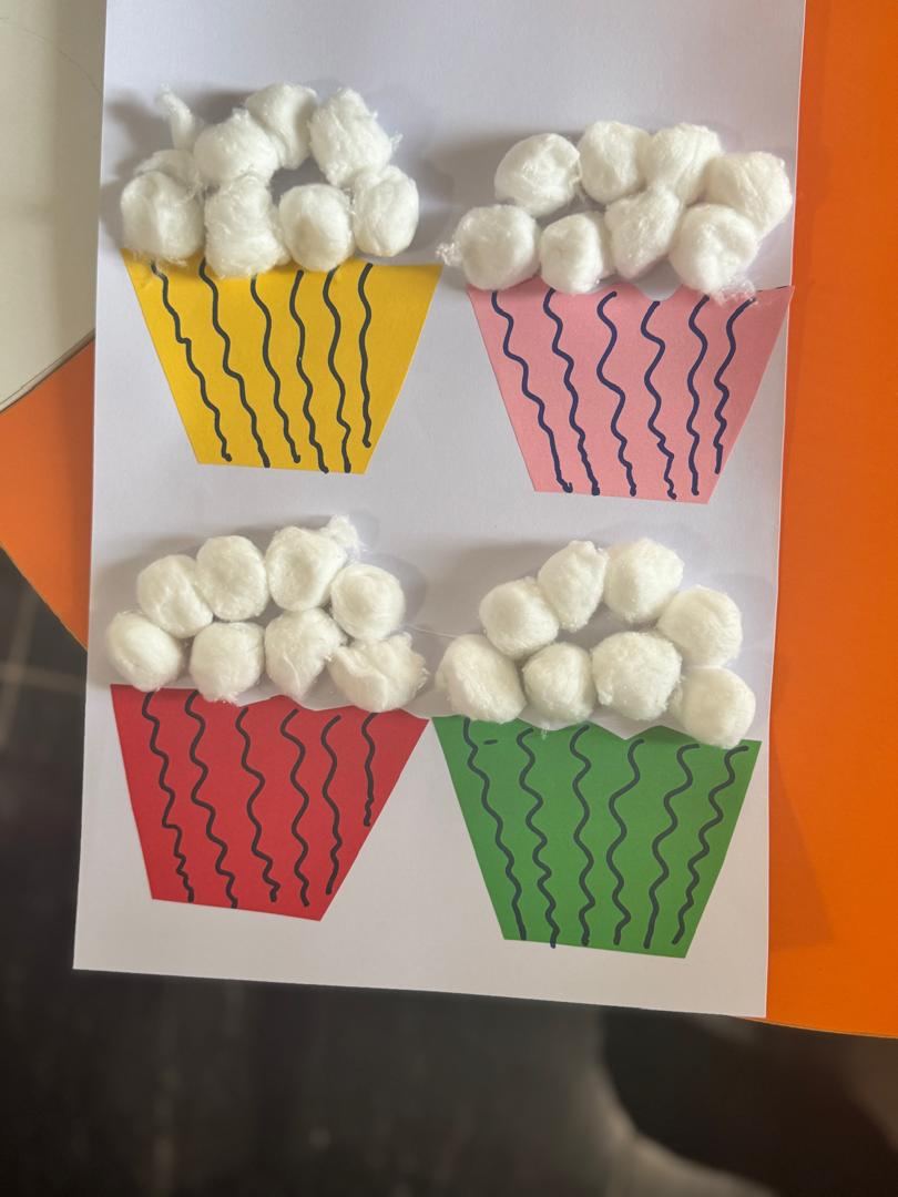 Children's cupcake craft work displayed on a table