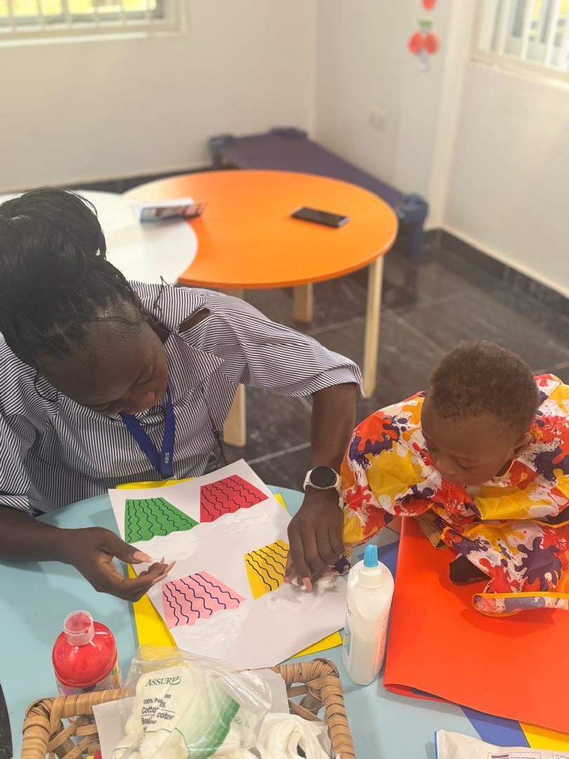 HoneyBerry teacher guiding a child during a creative activity